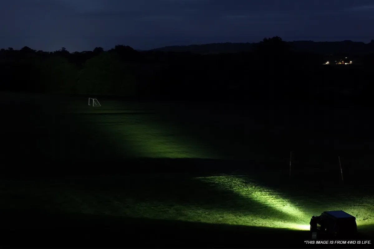 White auxiliary lighting spreading across a wide off road route