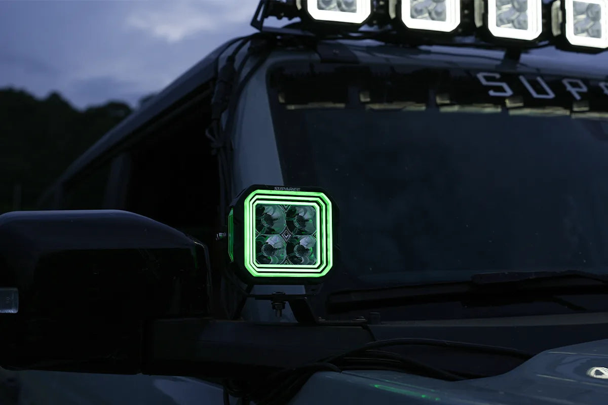 Hyper 5 RGBW LED pod light with green backlight installed on an off road vehicle
